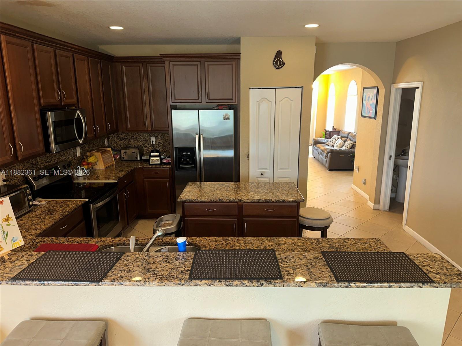 13986 Southwest 276th Way Homestead, FL 33032 - Photo 15 of 32 a living room with furniture and a fireplace