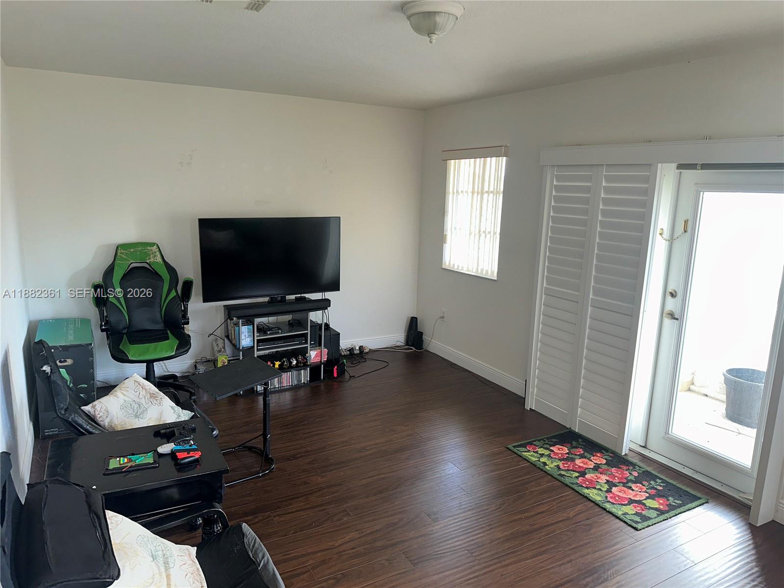 13986 Southwest 276th Way Homestead, FL 33032 - Photo 21 of 32 a living room with furniture and a flat screen tv