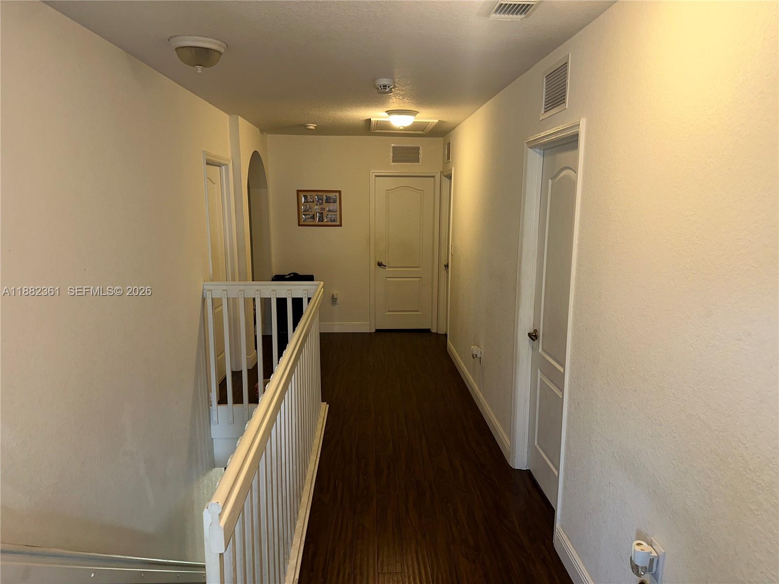 13986 Southwest 276th Way Homestead, FL 33032 - Photo 24 of 32 a view of a hallway with wooden floor and staircase