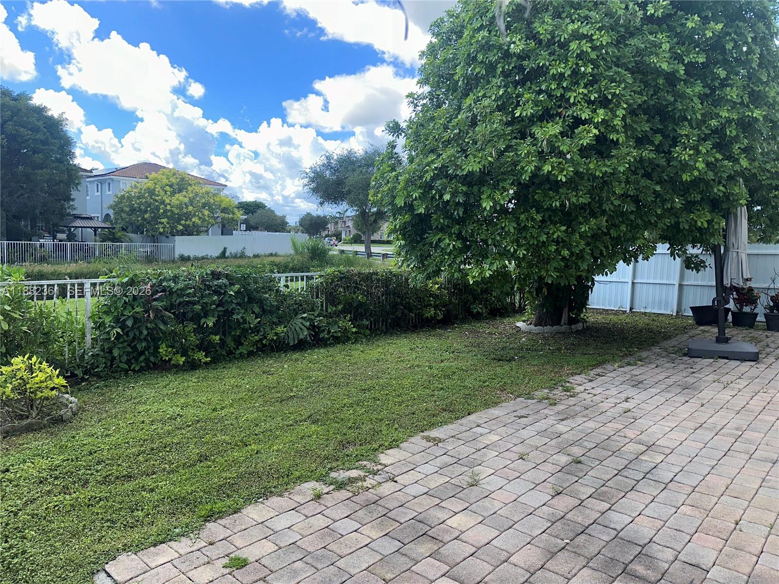 13986 Southwest 276th Way Homestead, FL 33032 - Photo 26 of 32 a view of a yard with plants and a large tree