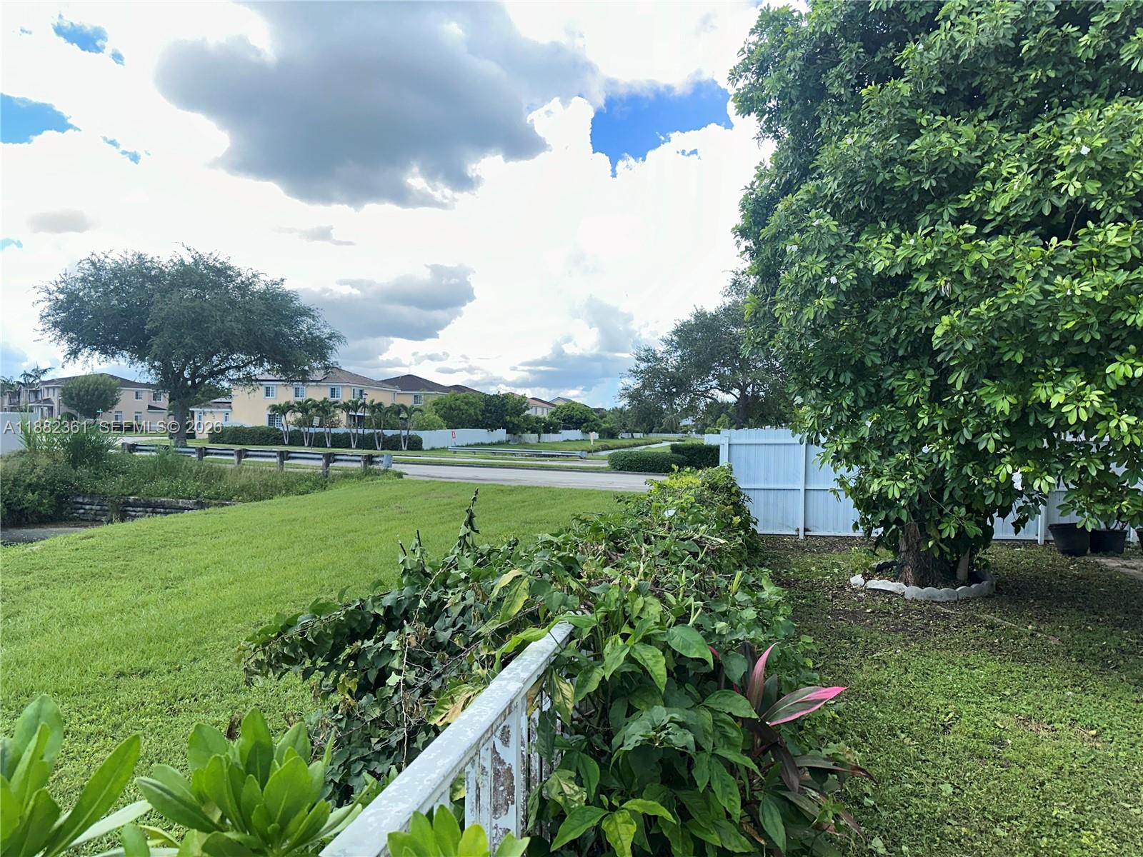 13986 Southwest 276th Way Homestead, FL 33032 - Photo 28 of 32 a view of a garden with a bench