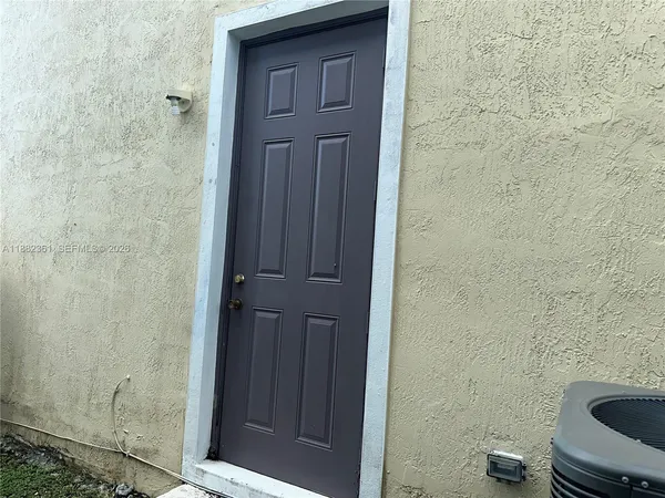 a view of entryway with window and flower pot