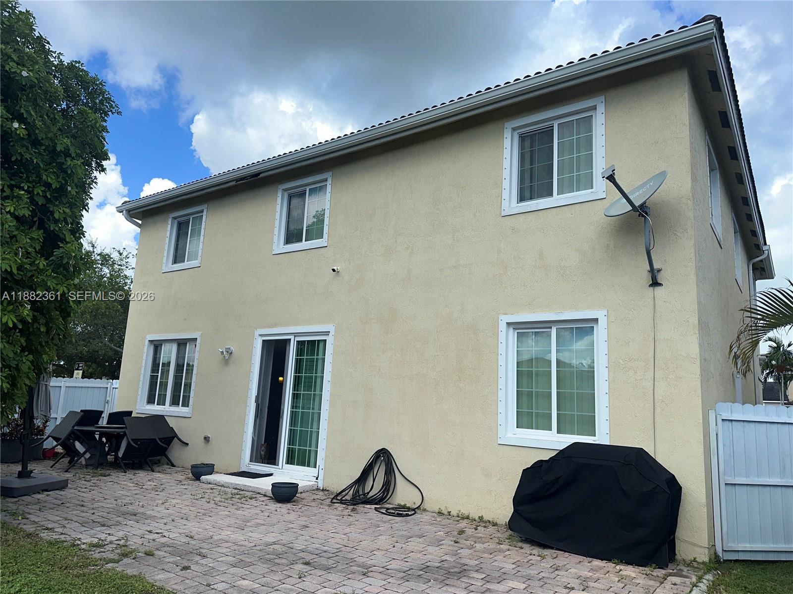 13986 Southwest 276th Way Homestead, FL 33032 - Photo 5 of 32 a view of a house with a patio