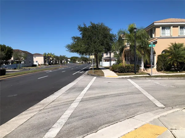 a view of a street with a building in the background