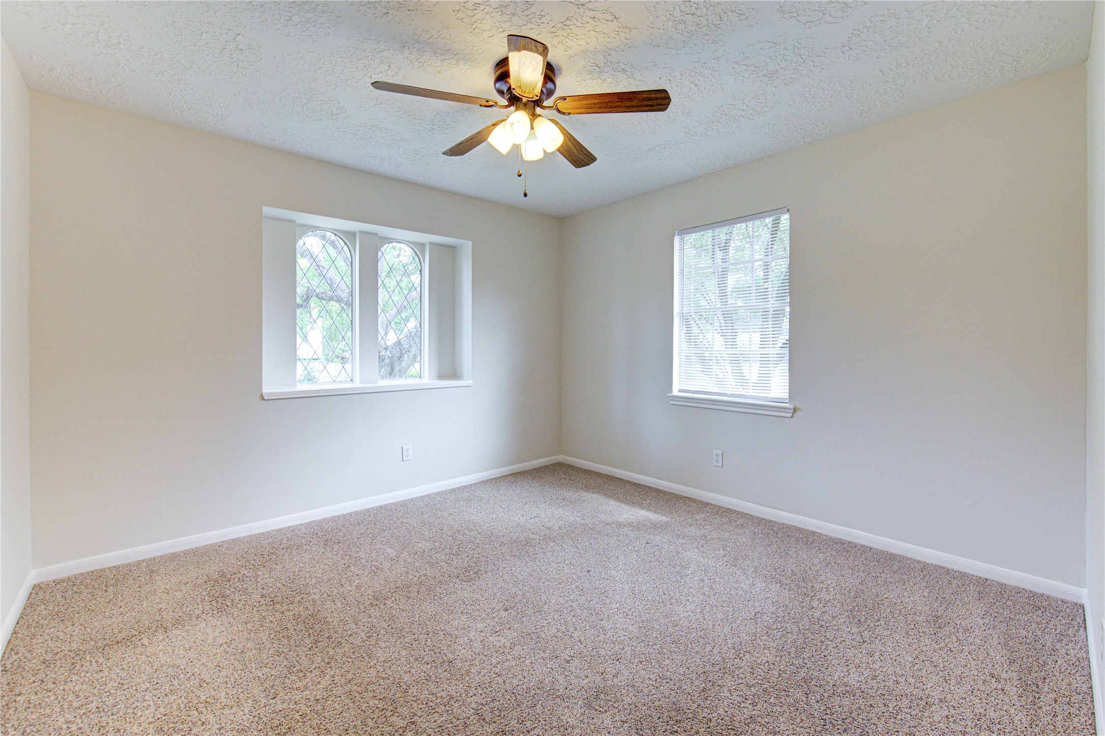 9115 Taidswood Drive Spring, TX 77379 - Photo 27 of 45 Bedroom 2 - All bedrooms have lighted ceiling fans, neutral paint and carpeting, and large walk-in closets!