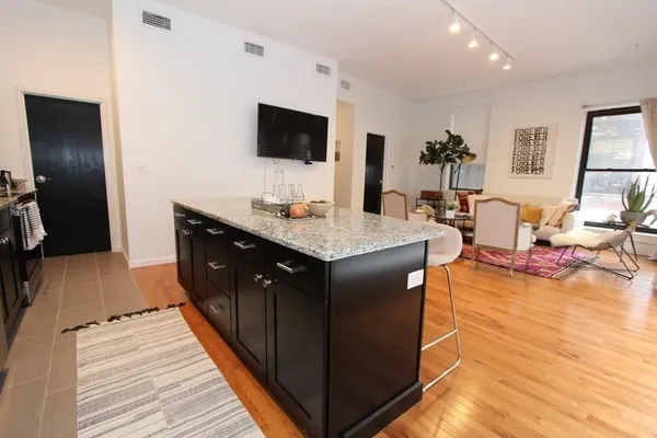 a kitchen with a sink appliances and cabinets