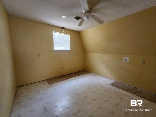 32749 Antietam Road Lillian, AL 36549 - Photo 26 of 47 Additional living space featuring ceiling fan, a textured ceiling, and vaulted ceiling