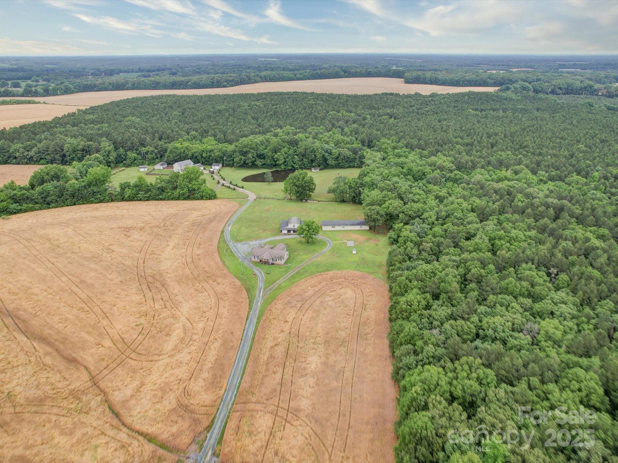 4115 Jenkins Road Marshville, NC 28103 - Photo 11 of 39 a view of a garden with a building in the background