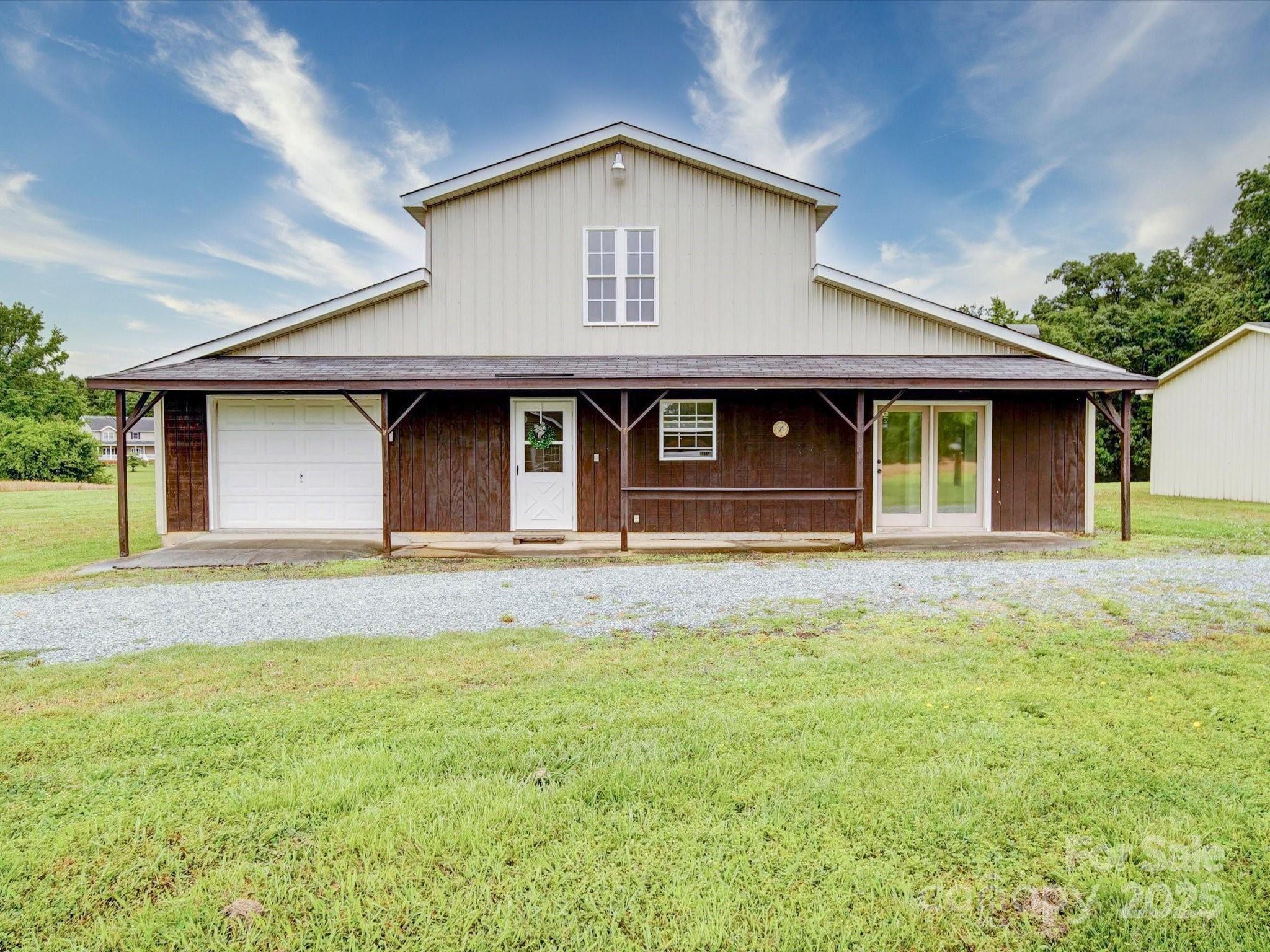 4115 Jenkins Road Marshville, NC 28103 - Photo 12 of 39 a front view of a house with a garden and garage