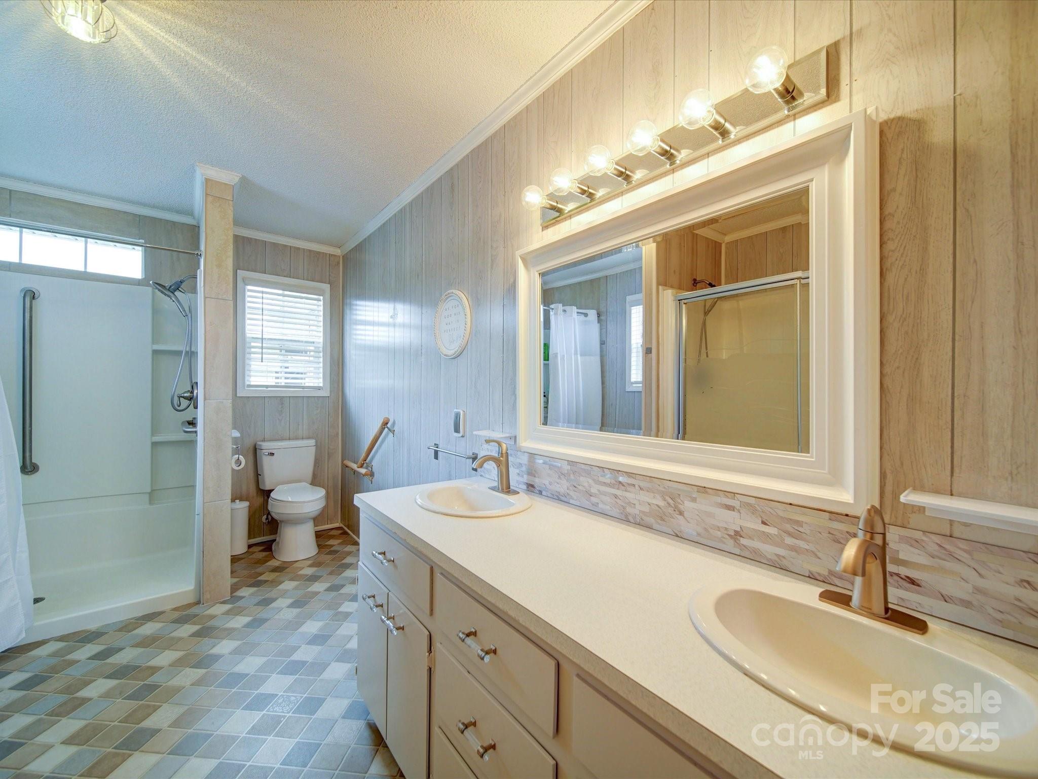 4115 Jenkins Road Marshville, NC 28103 - Photo 19 of 39 a spacious bathroom with a granite countertop sink a toilet and a shower
