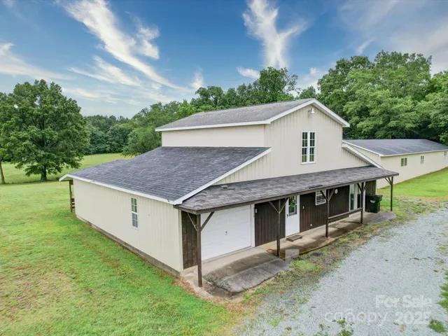 a aerial view of a house with a yard balcony and garage