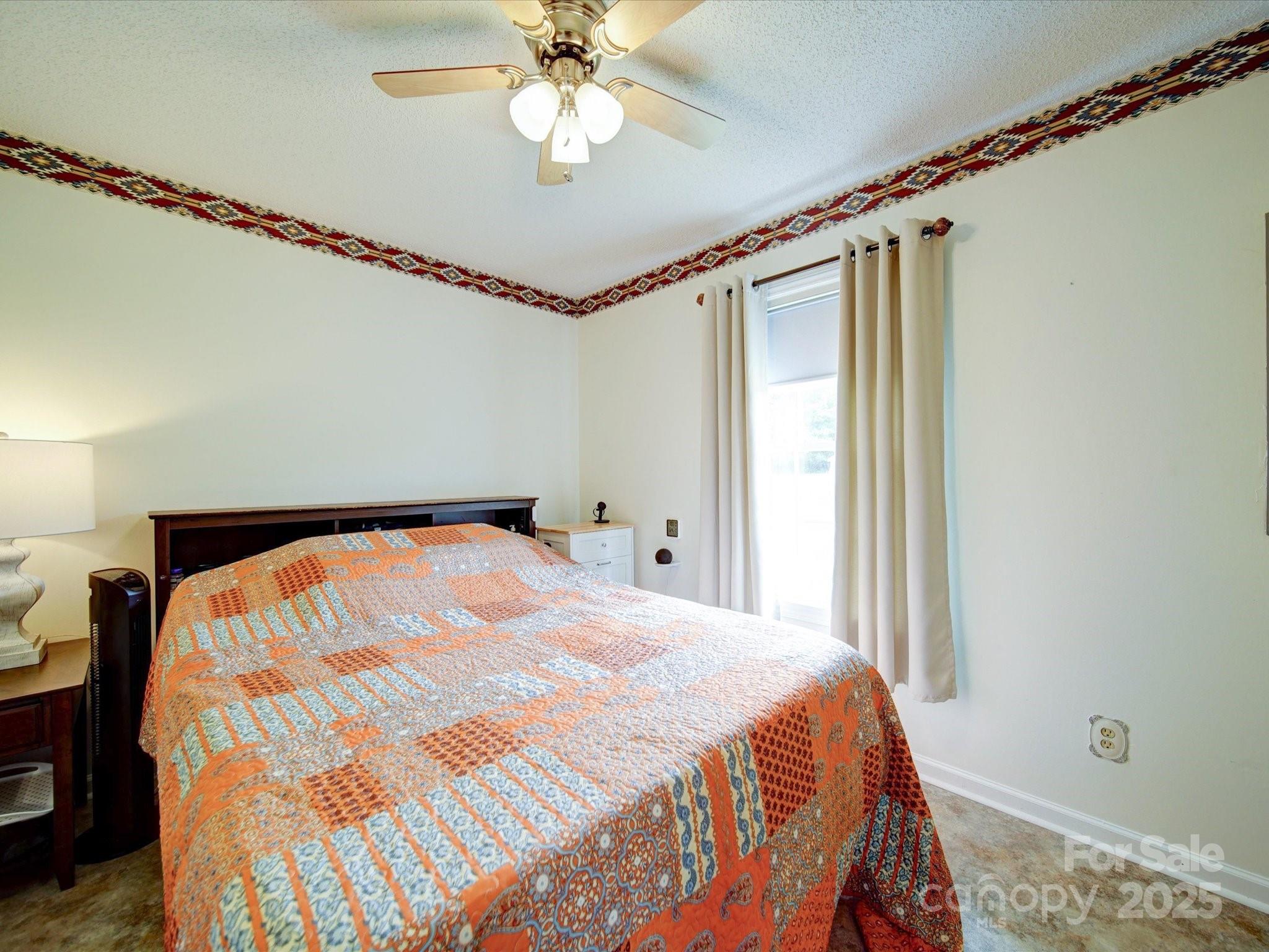 4115 Jenkins Road Marshville, NC 28103 - Photo 32 of 39 a bedroom with a bed and a chandelier