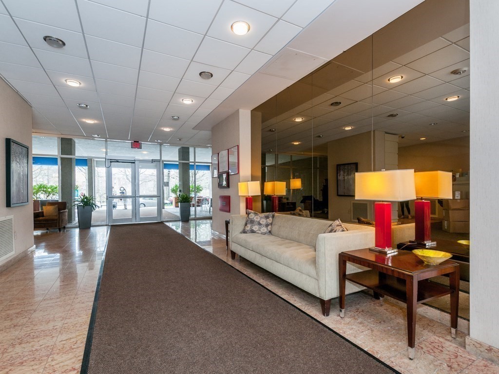 33 Pond Avenue, Unit 524 Brookline, MA 02445 - Photo 25 of 26 a lobby with furniture and a potted plant