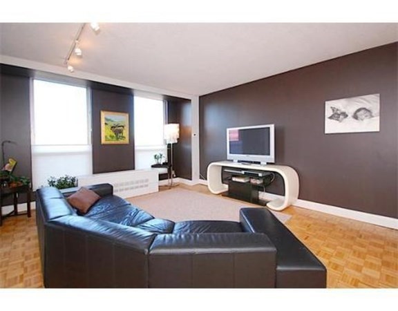 33 Pond Avenue, Unit 524 Brookline, MA 02445 - Photo 4 of 26 a bedroom with a bed and wooden floor