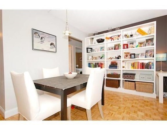 33 Pond Avenue, Unit 524 Brookline, MA 02445 - Photo 6 of 26 a view of a dining room with furniture and wooden floor