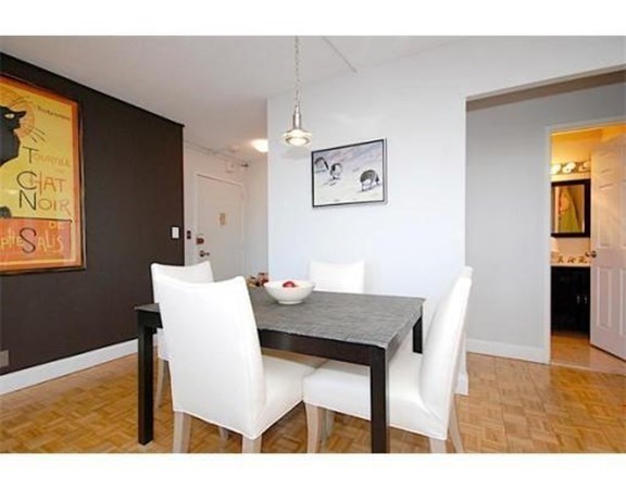 33 Pond Avenue, Unit 524 Brookline, MA 02445 - Photo 7 of 26 a view of a dining room with furniture and wooden floor