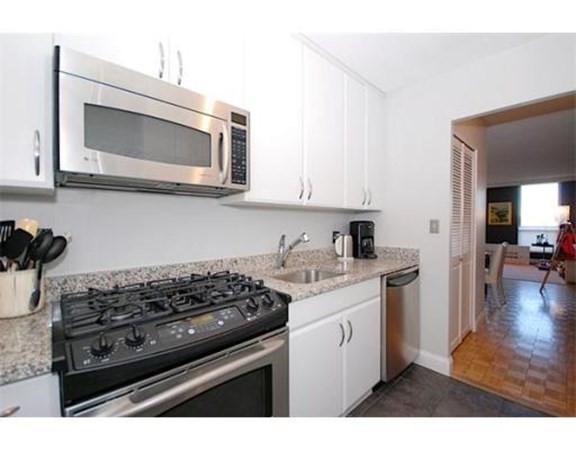 33 Pond Avenue, Unit 524 Brookline, MA 02445 - Photo 8 of 26 a kitchen with a stove and a microwave