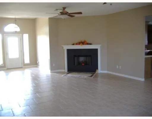 a view of an empty room with a fireplace
