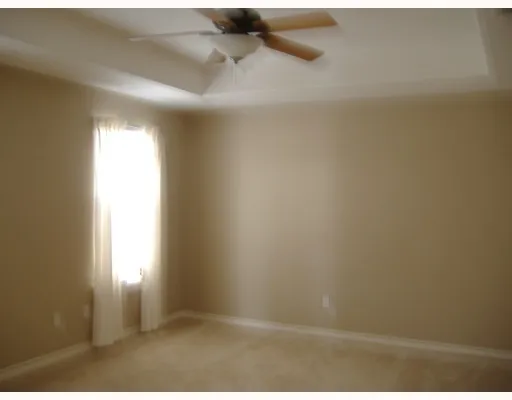 a view of a chandelier fan and wooden floor