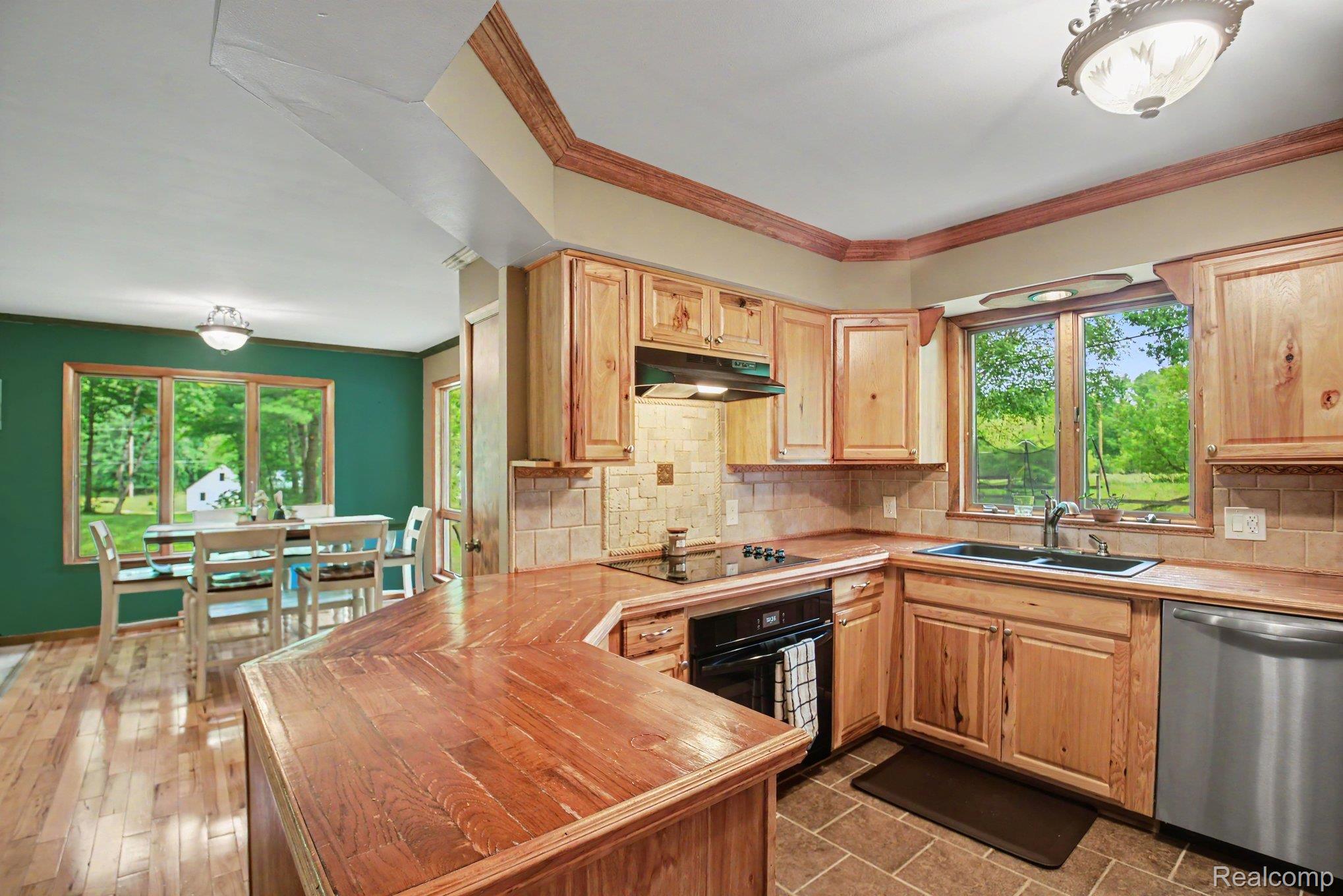 1646 Boy Scout Road Caro, MI 48723 - Photo 6 of 28 Kitchen featuring natural wood cabinetry, wood-finish countertops, and a stainless steel dishwasher