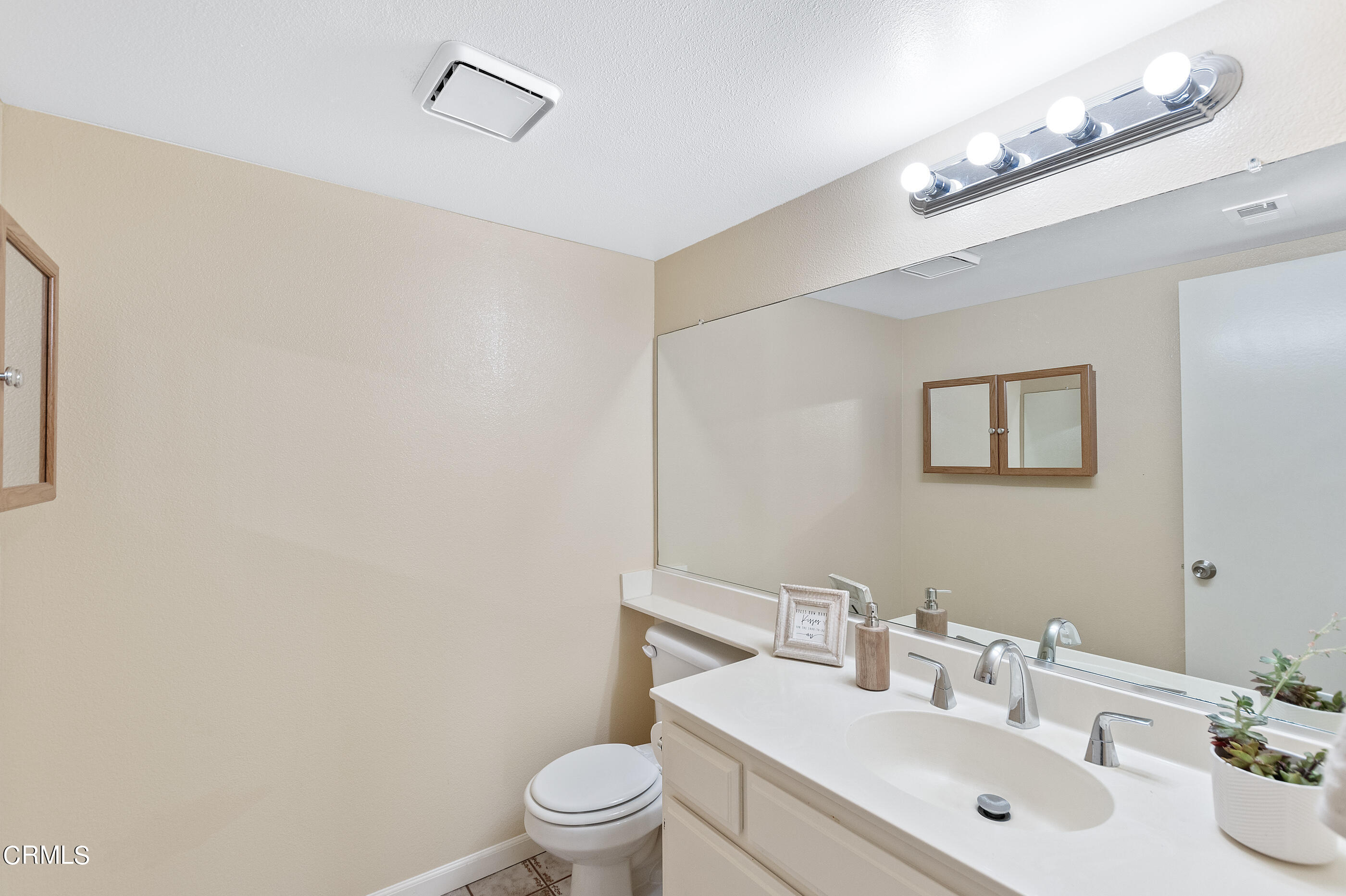 3510 Olds Road Oxnard, CA 93033 - Photo 25 of 36 a bathroom with a toilet a sink and mirror