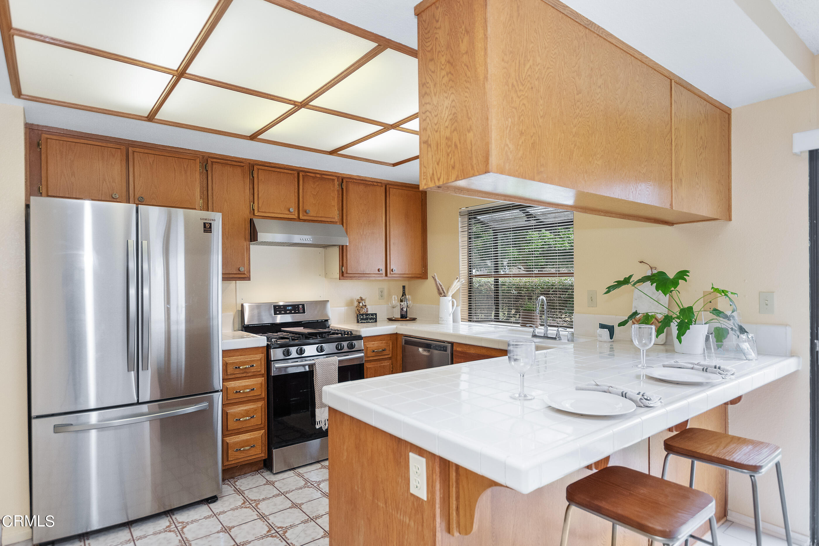 3510 Olds Road Oxnard, CA 93033 - Photo 7 of 36 a kitchen with stainless steel appliances granite countertop a sink a stove a refrigerator cabinets a dining table and chairs