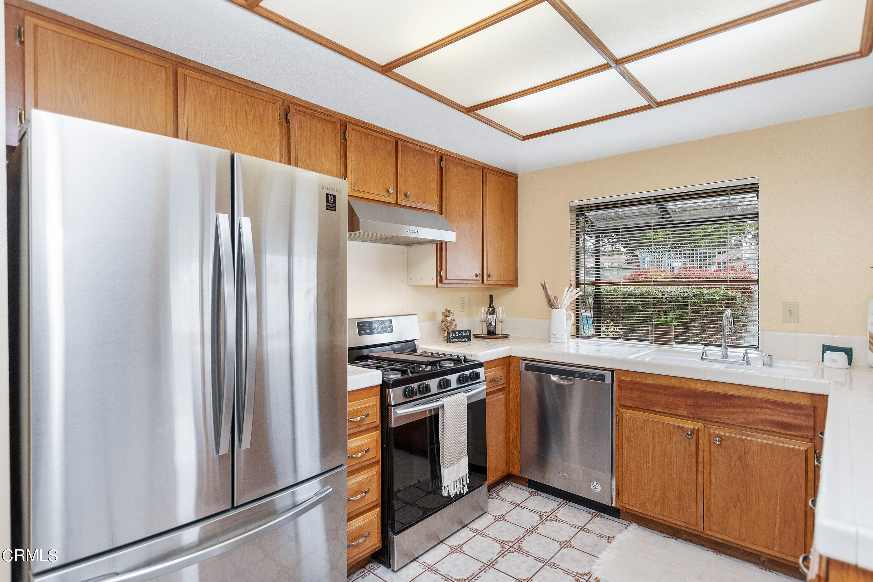 3510 Olds Road Oxnard, CA 93033 - Photo 8 of 36 a kitchen with a stove a sink and a refrigerator