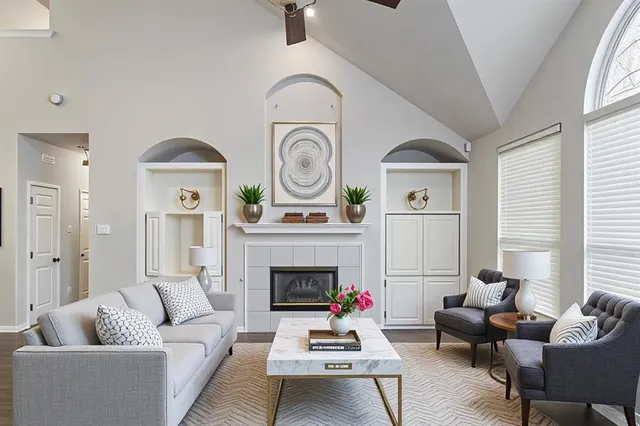 a living room with furniture a clock and a fireplace