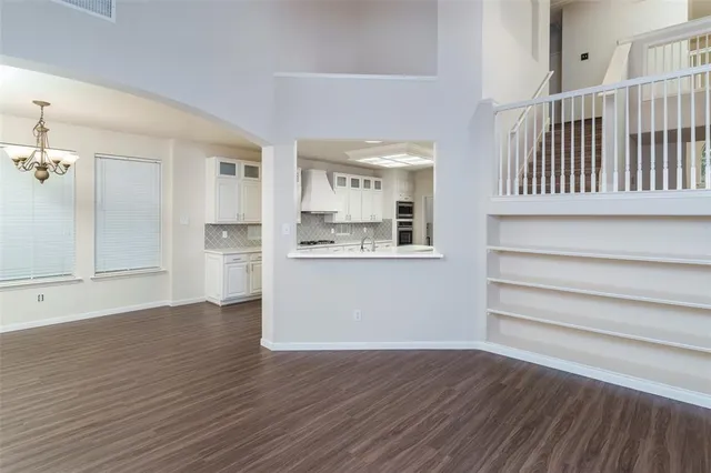 a view of kitchen with wooden floor and electronic appliances