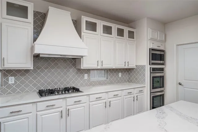 a kitchen with cabinets appliances and wooden floor