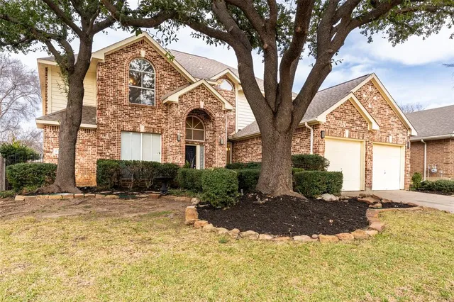 a view of a large trees in front of a house