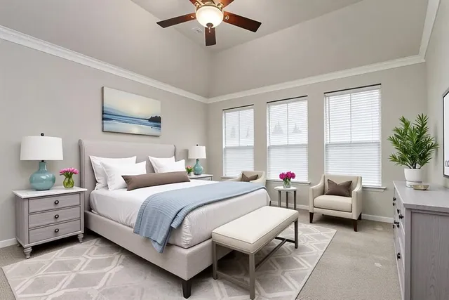 a bedroom with a bed a couch and potted plant