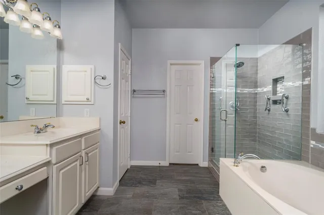 a bathroom with a tub sink and mirror