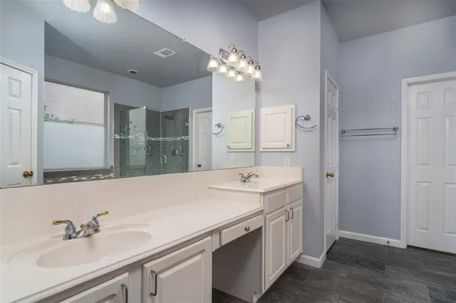 a bathroom with a sink double vanity granite and a mirror