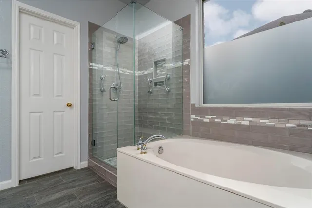 a bathroom with a bathtub and a shower