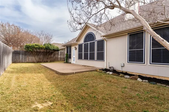 a view of pool with two chairs next to a yard