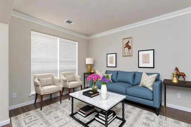 a living room with furniture potted plant and window