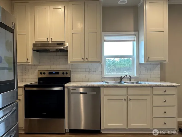a kitchen with a sink stove and refrigerator