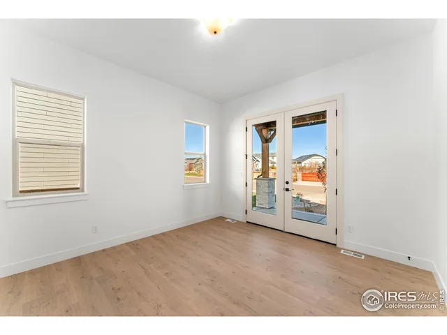 a view of a room with window and hardwood floor