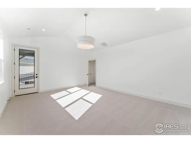 a view of an empty room with windows