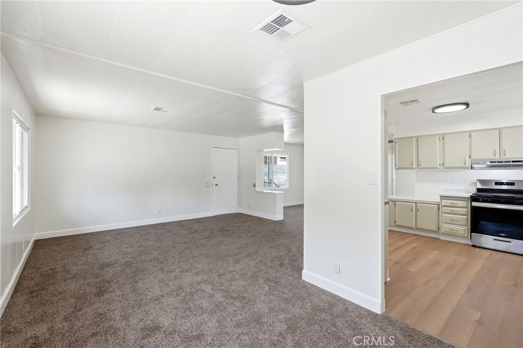 2250 West Mill Street, Unit 104 Colton, CA 92324 - Photo 12 of 28 a view of a kitchen with a sink and dishwasher a stove top oven with wooden floor