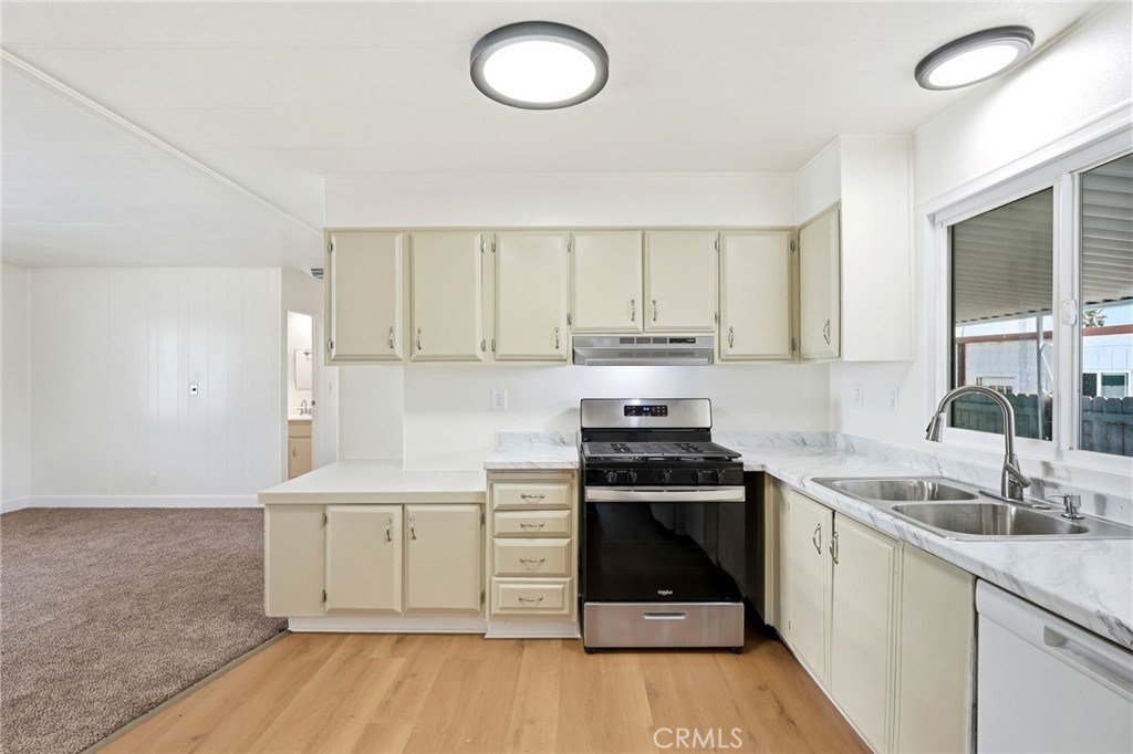 2250 West Mill Street, Unit 104 Colton, CA 92324 - Photo 14 of 28 a kitchen with a sink stove and cabinets