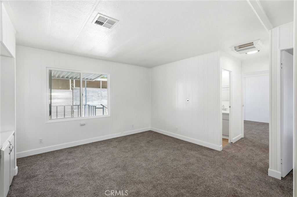 2250 West Mill Street, Unit 104 Colton, CA 92324 - Photo 17 of 28 wooden floor in an empty room with a window