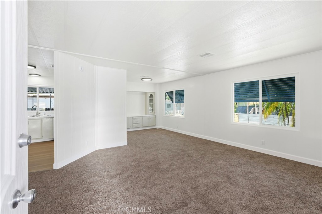 2250 West Mill Street, Unit 104 Colton, CA 92324 - Photo 7 of 28 an empty room with windows and entrance