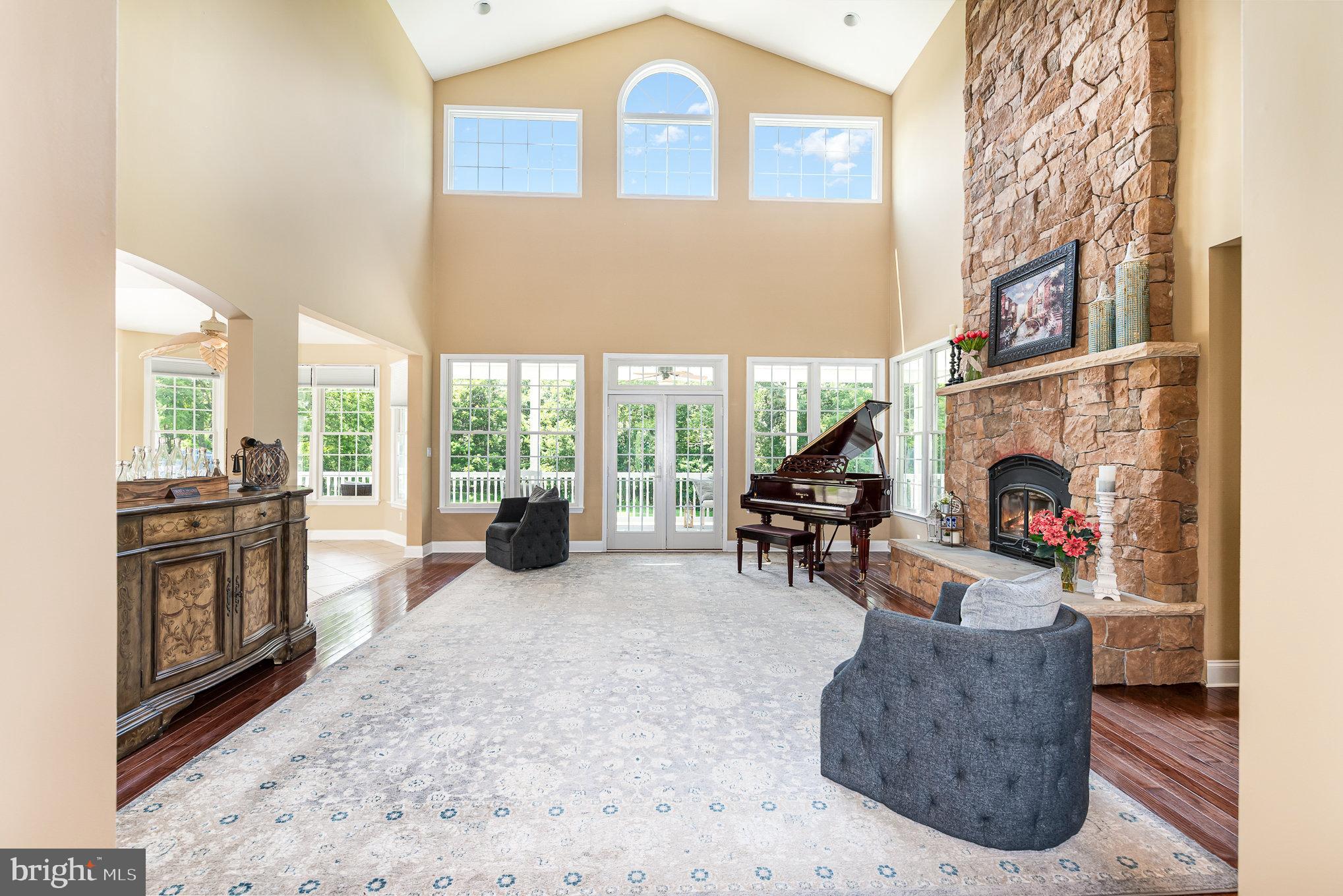 5330 Long Corner Road White Hall, MD 21161 - Photo 13 of 66 a living room with furniture a fireplace and a floor to ceiling window