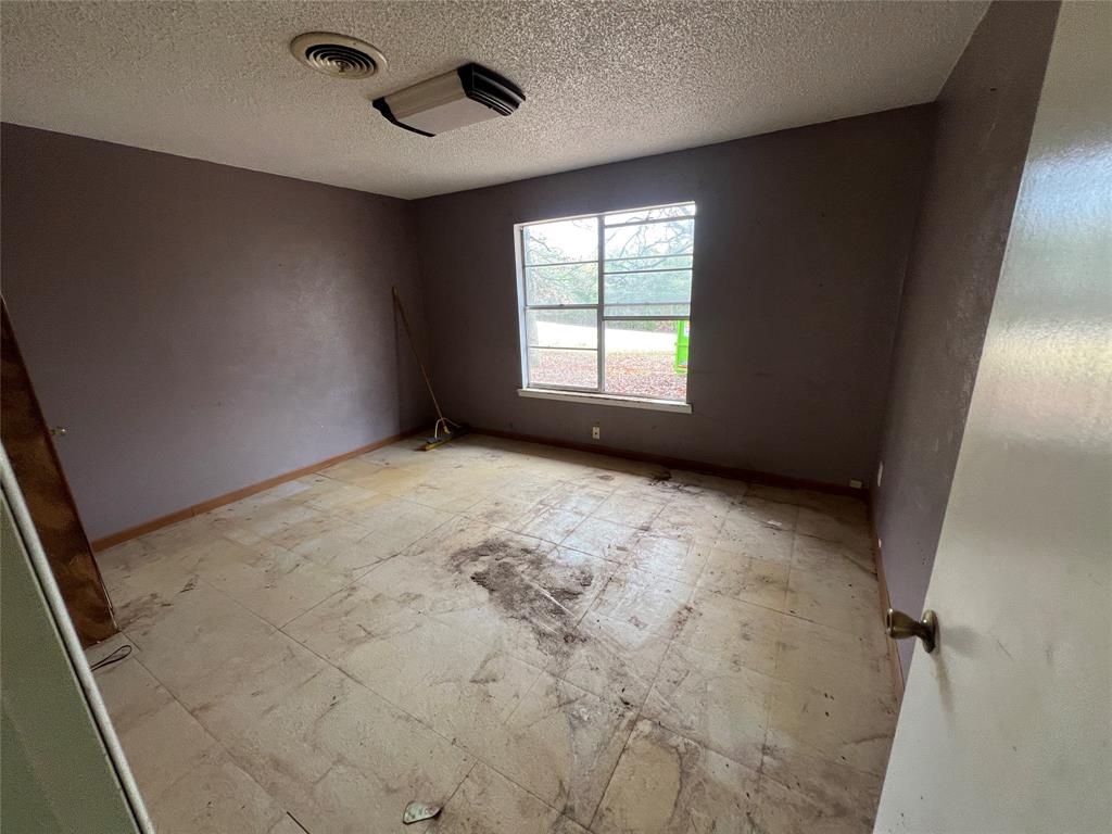 492 Richerson Road Denison, TX 75021 - Photo 13 of 29 a view of an empty room with a window