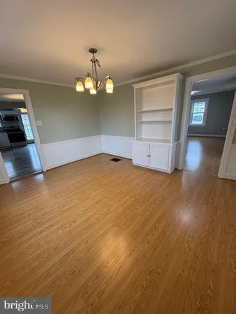 a view of a room with wooden floor and window