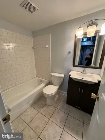 a bathroom with a sink a toilet and bathtub