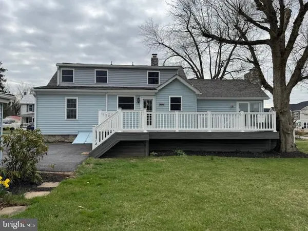 a house that has a tree in front of it
