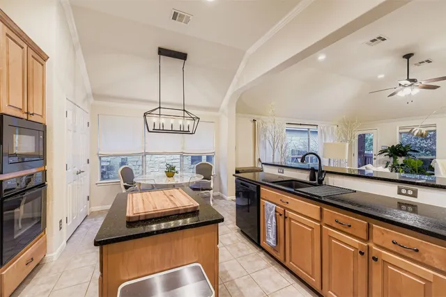 a kitchen with stainless steel appliances granite countertop a sink and a stove